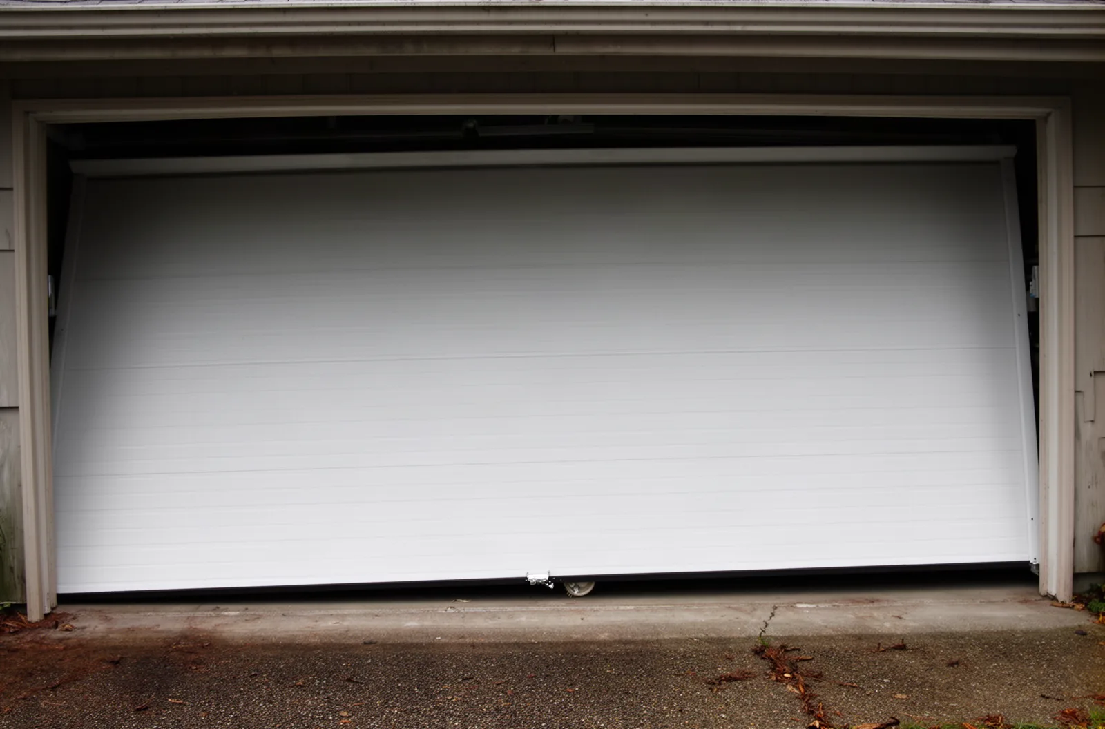 A garage door sitting slightly crooked with one roller out of the track